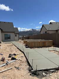 a backyard with a concrete patio under construction
